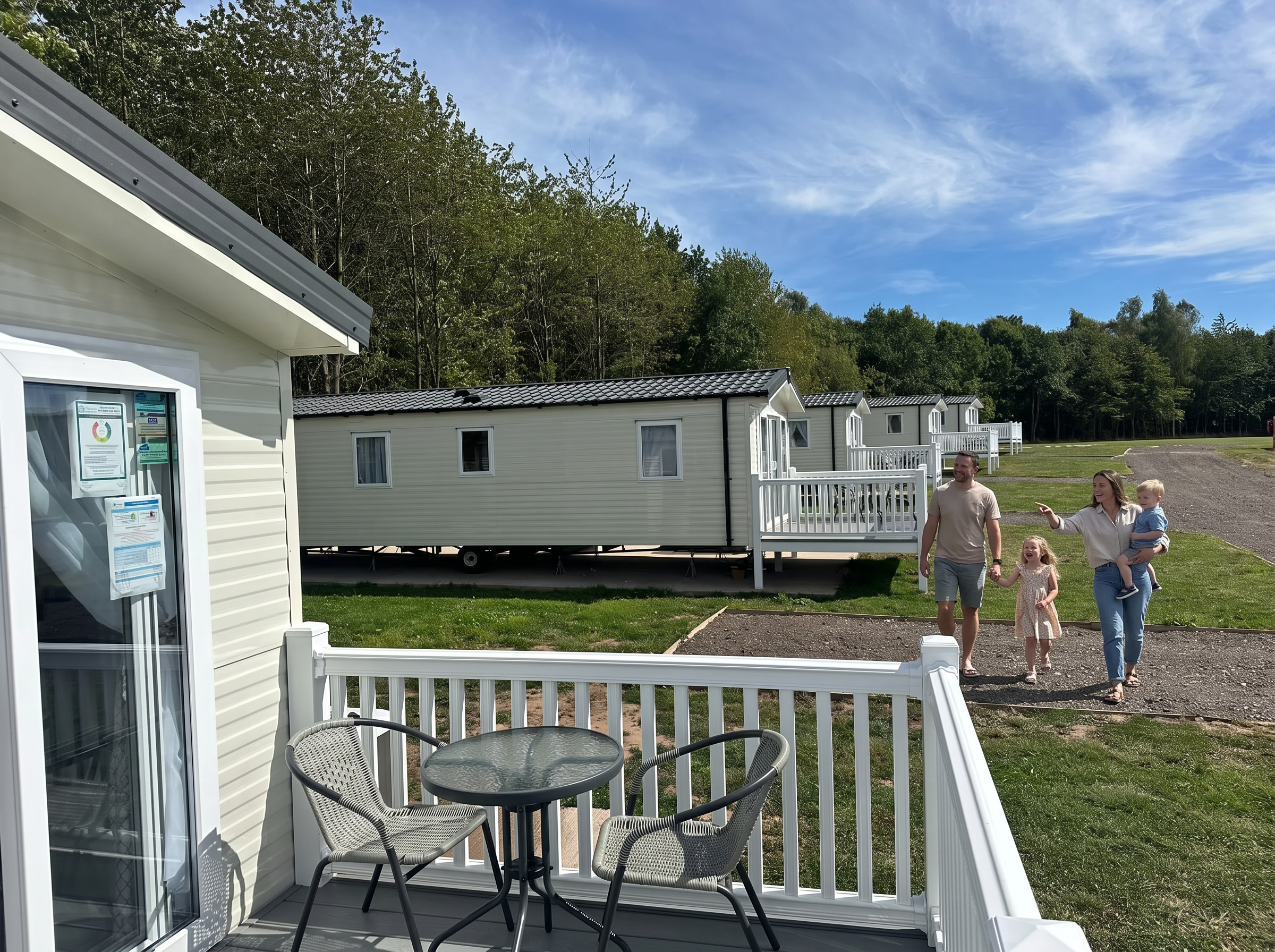 A family walking past the lodges at Swanlake